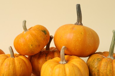 Thanksgiving day. Beautiful composition with pumpkins on beige background, closeup