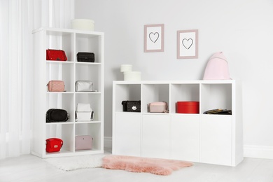 Photo of Wardrobe shelves with different stylish bags indoors. Idea for interior design