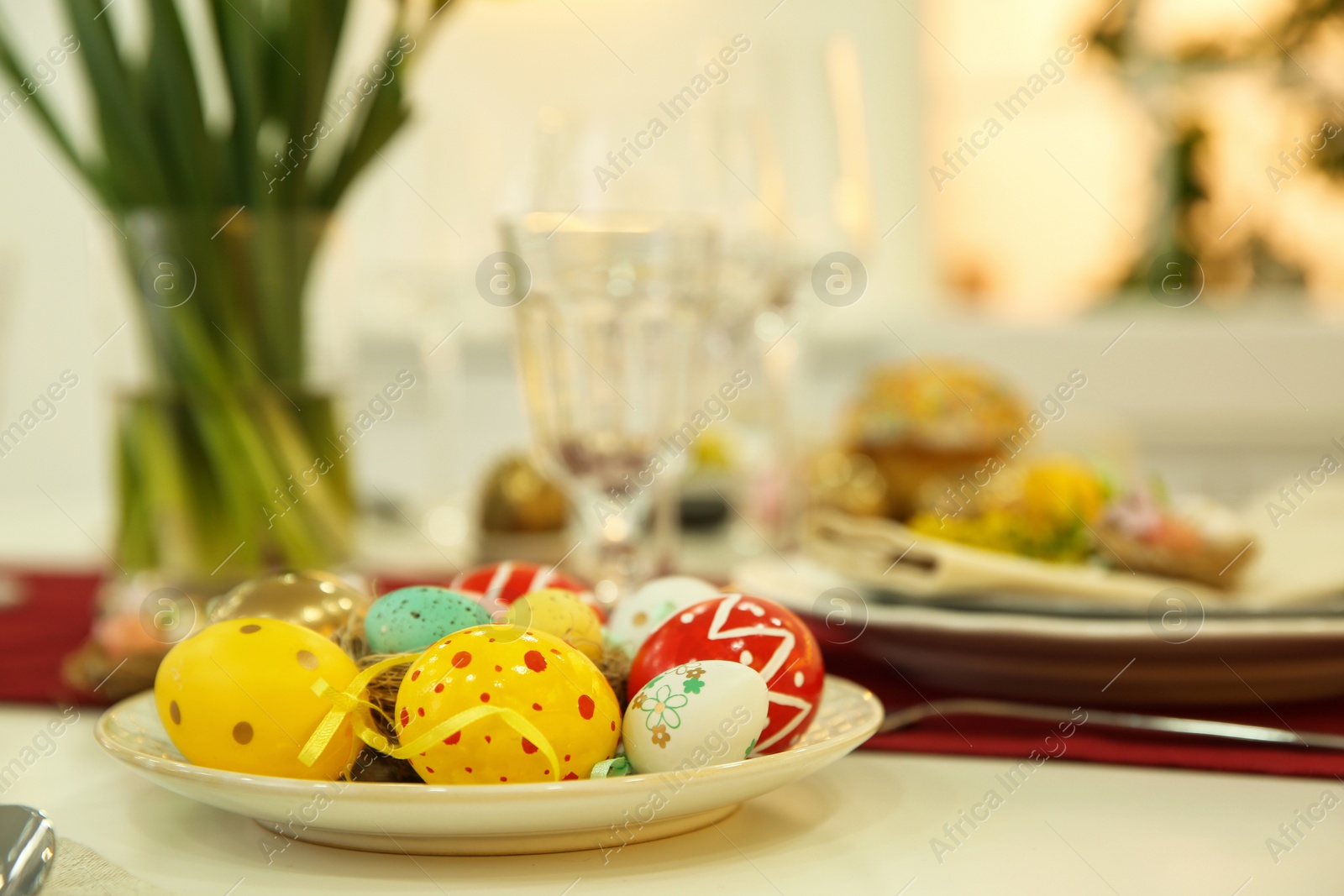 Photo of Festive Easter table setting with decorated eggs