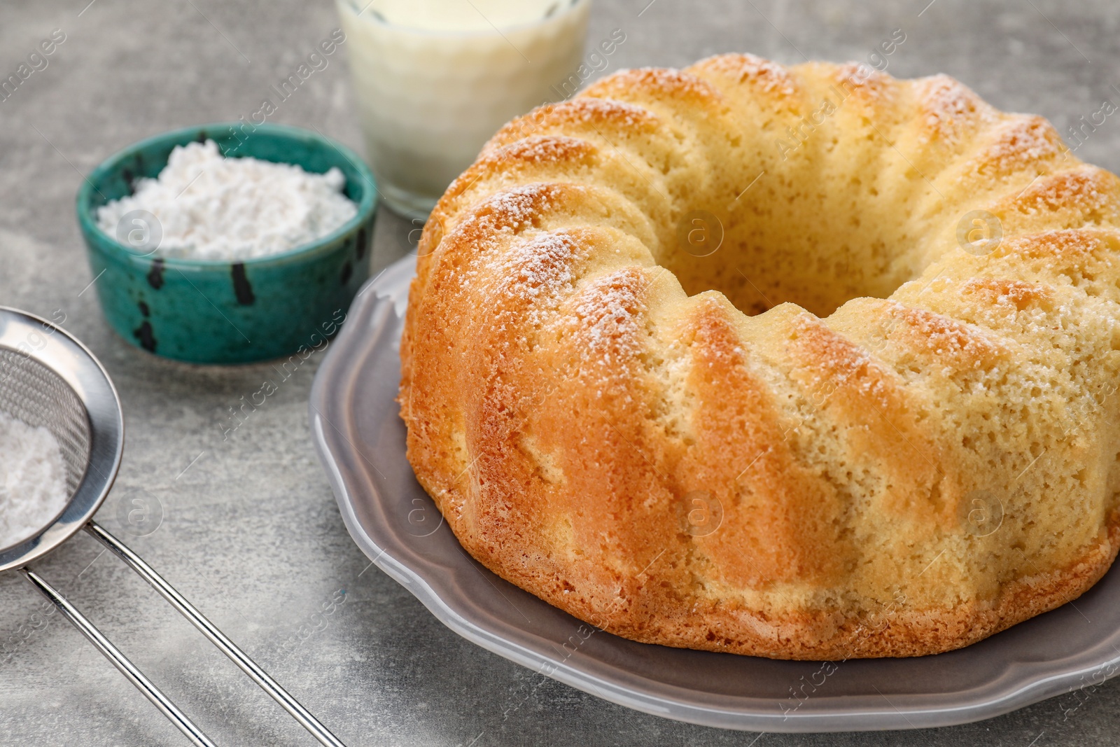 Photo of Delicious freshly baked sponge cake on gray table, closeup