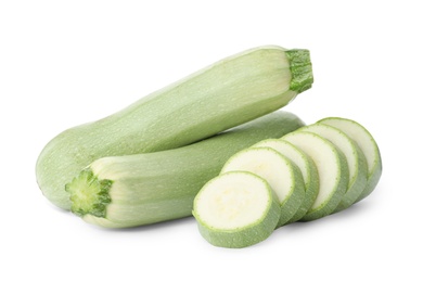 Photo of Cut and whole green ripe zucchinis on white background