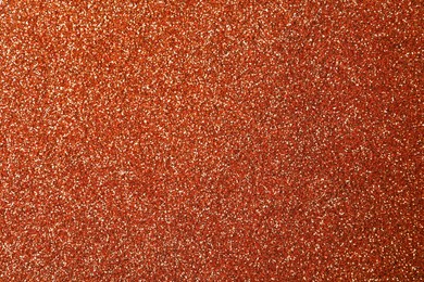 Photo of Beautiful shiny copper glitter as background, closeup