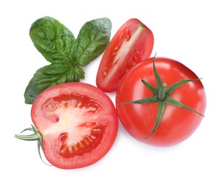 Photo of Fresh green basil leaves with cut and whole tomatoes on white background, top view