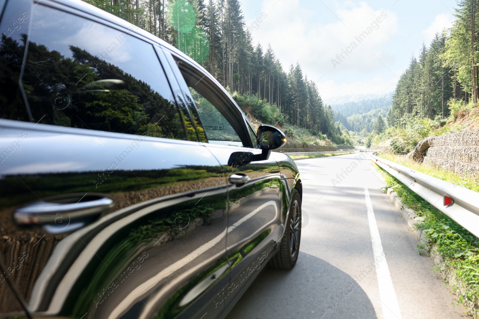 Photo of Modern black car on asphalt road outdoors