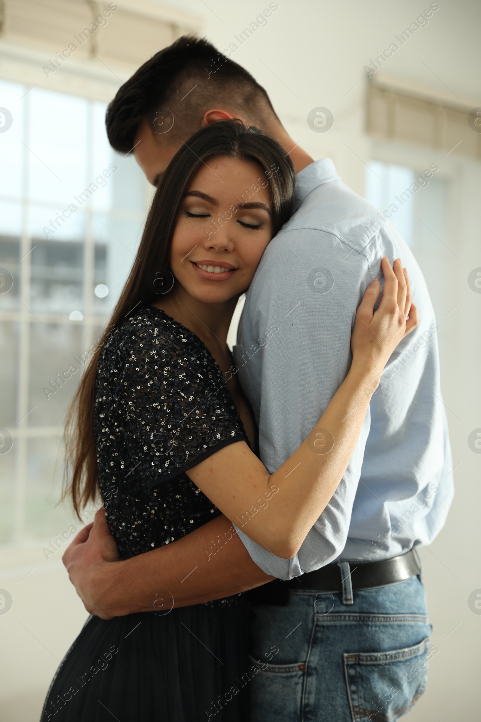 Photo of Lovely young couple dancing together in ballroom