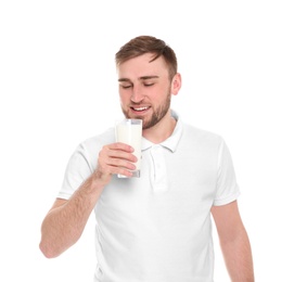 Young man drinking tasty milk on white background