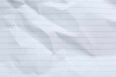 Photo of Crumpled lined notebook sheet as background, top view