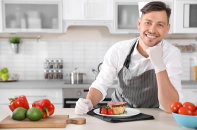 Photo of Professional chef in uniform at restaurant kitchen