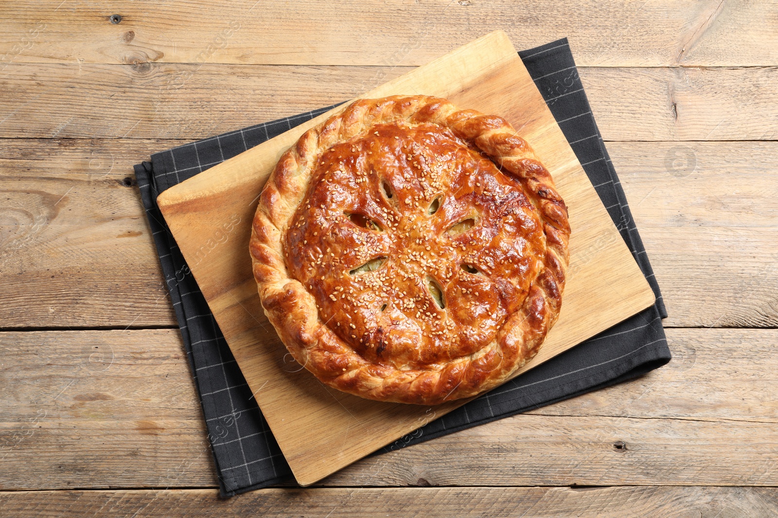 Photo of Tasty homemade pie with filling on wooden table, top view