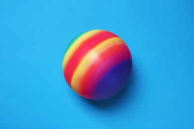 Photo of New bright kids' ball on light blue background, top view