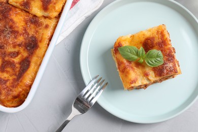 Tasty cooked lasagna served on grey table, flat lay