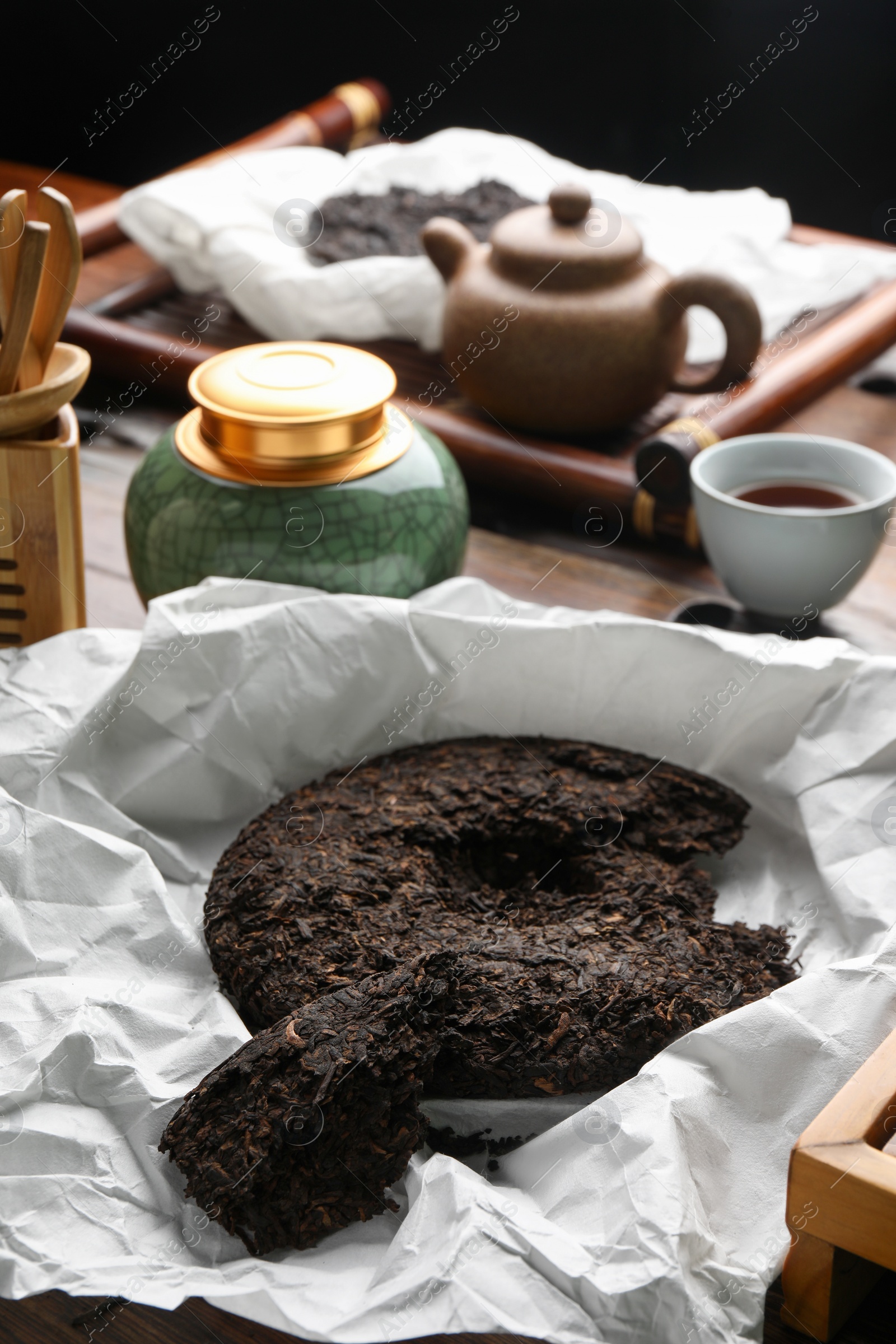 Photo of Broken disc shaped pu-erh tea on table