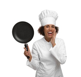Emotional female chef in uniform holding frying pan on white background