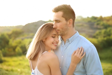 Photo of Cute young couple in love posing outdoors on sunny day