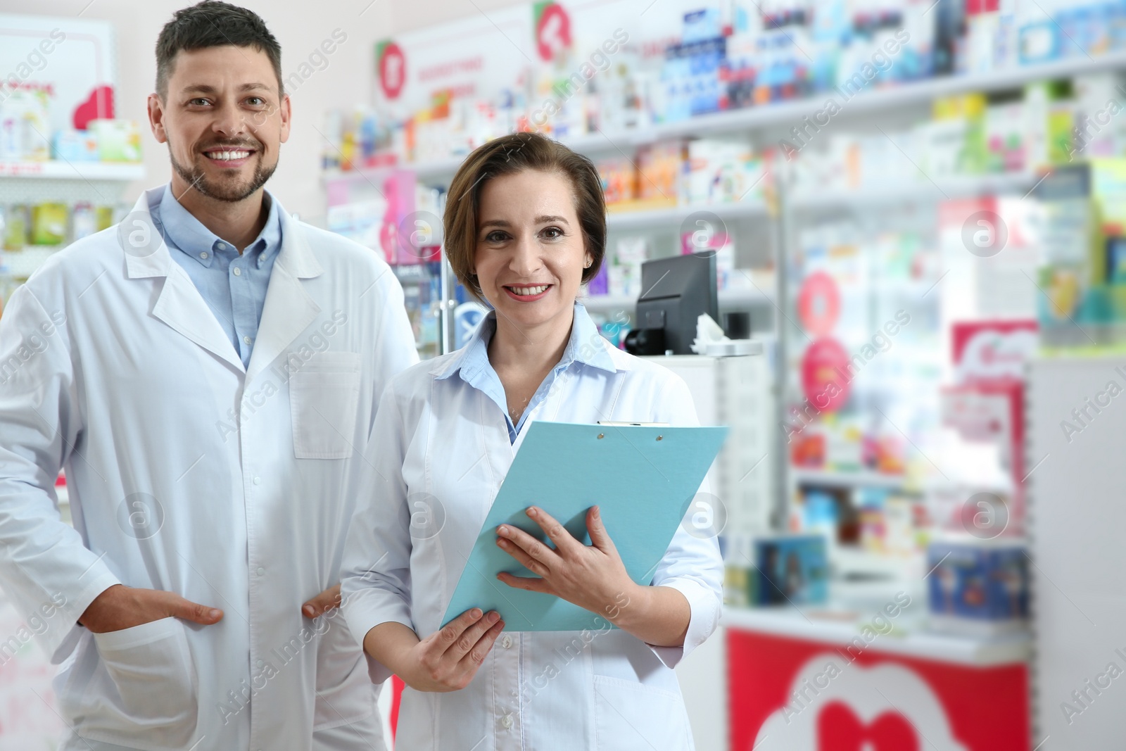 Photo of Portrait of professional pharmacists in modern drugstore