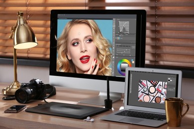 Retoucher's workplace. Computer and laptop with photo editor applications, camera, graphic tablet on table indoors