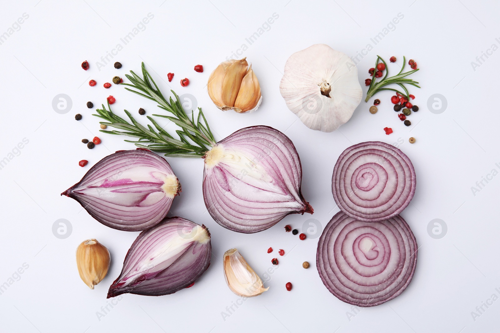 Photo of Fresh red onions, garlic, rosemary and spices on white background, flat lay