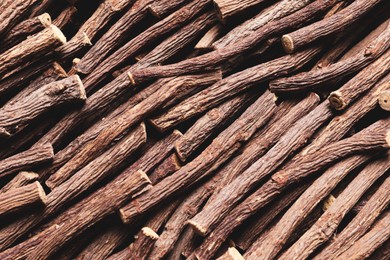Photo of Dried sticks of liquorice root as background, top view