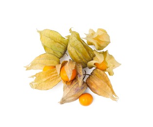 Photo of Many ripe physalis fruits with calyxes isolated on white, top view