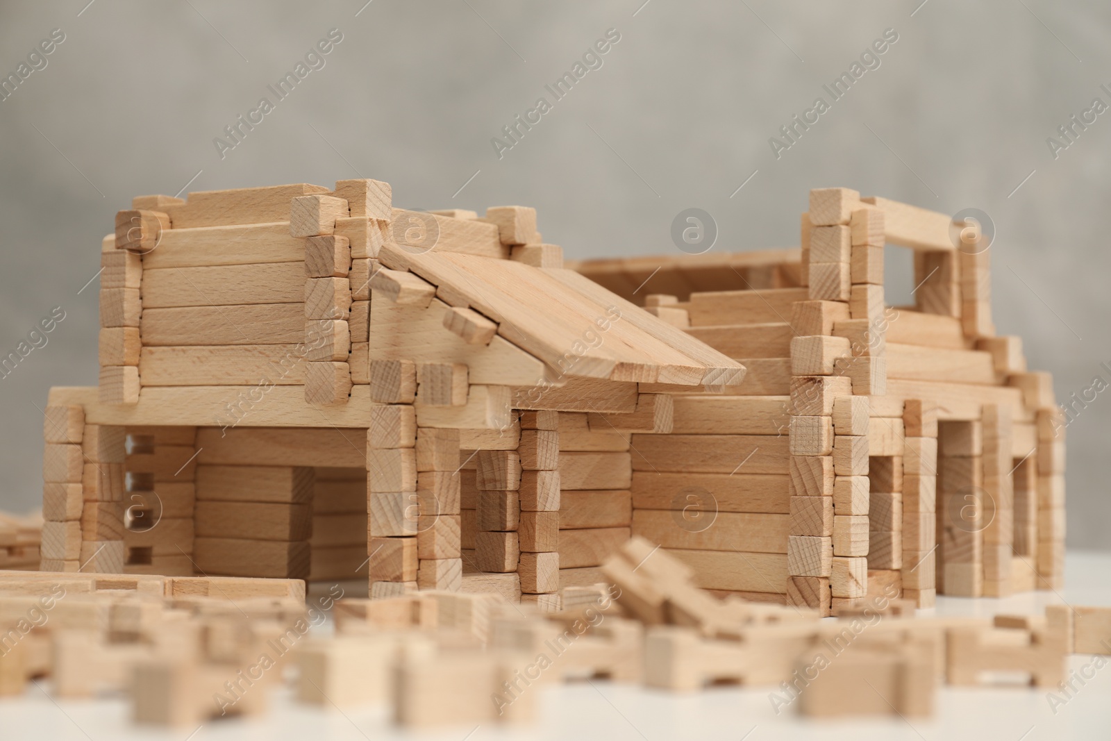 Photo of Wooden construction set on white table, closeup. Children's toy