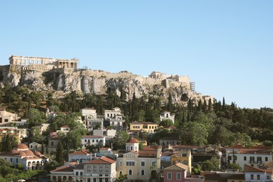 Photo of Picturesque view of cityscape with beautiful houses and acropolis on sunny day