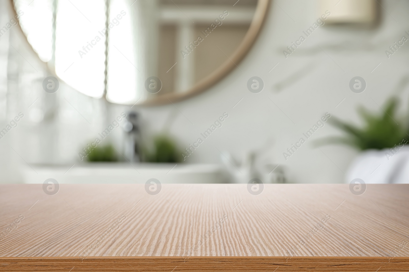 Image of Empty wooden table and blurred view of stylish bathroom interior