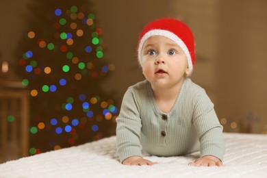 Photo of Cute little baby in room decorated for Christmas. Winter holiday