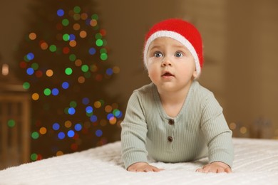 Cute little baby in room decorated for Christmas. Winter holiday