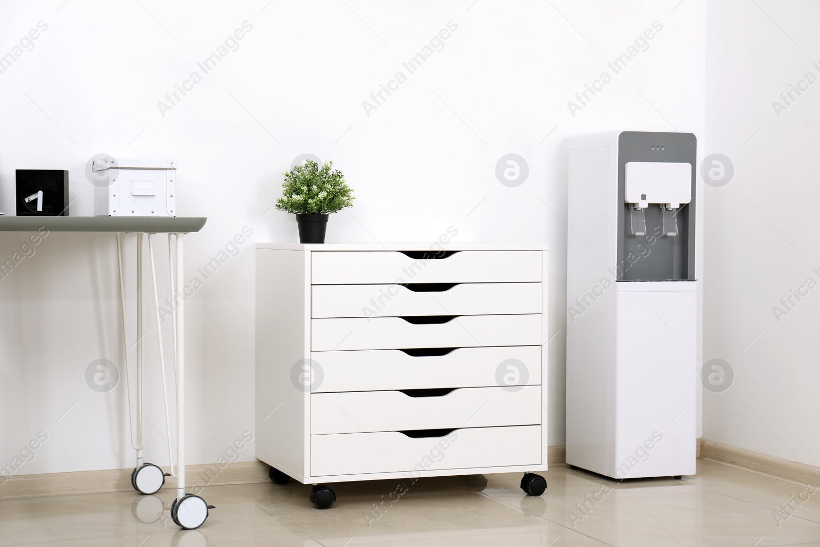 Photo of Modern water cooler in stylish office interior