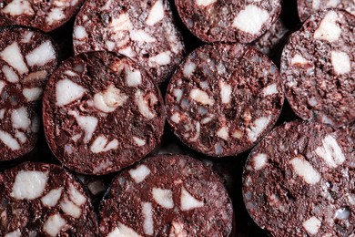 Photo of Slices of tasty blood sausage as background, top view