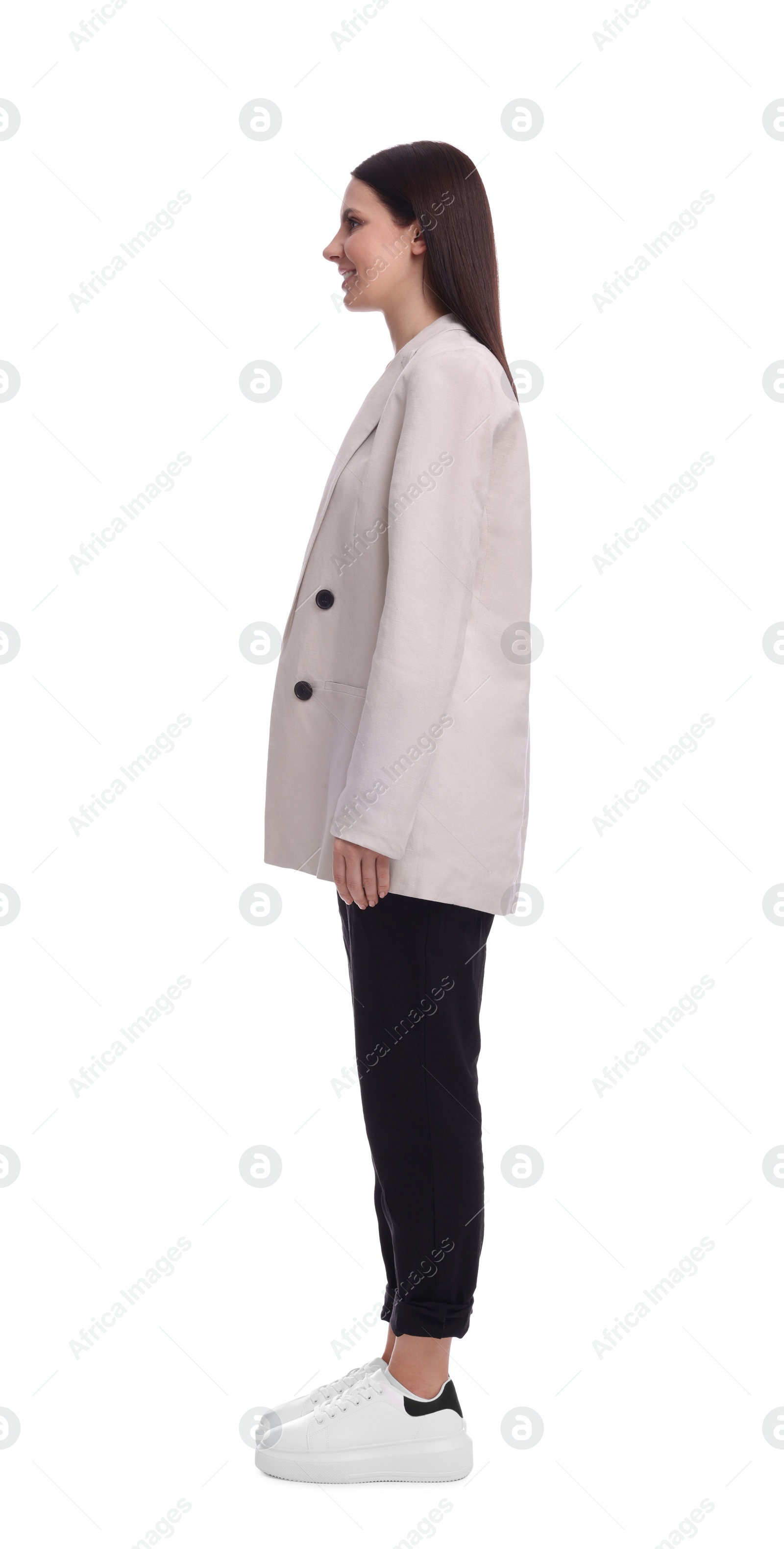 Photo of Young businesswoman in suit standing on white background