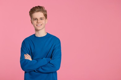 Photo of Portrait of teenage boy on pink background. Space for text