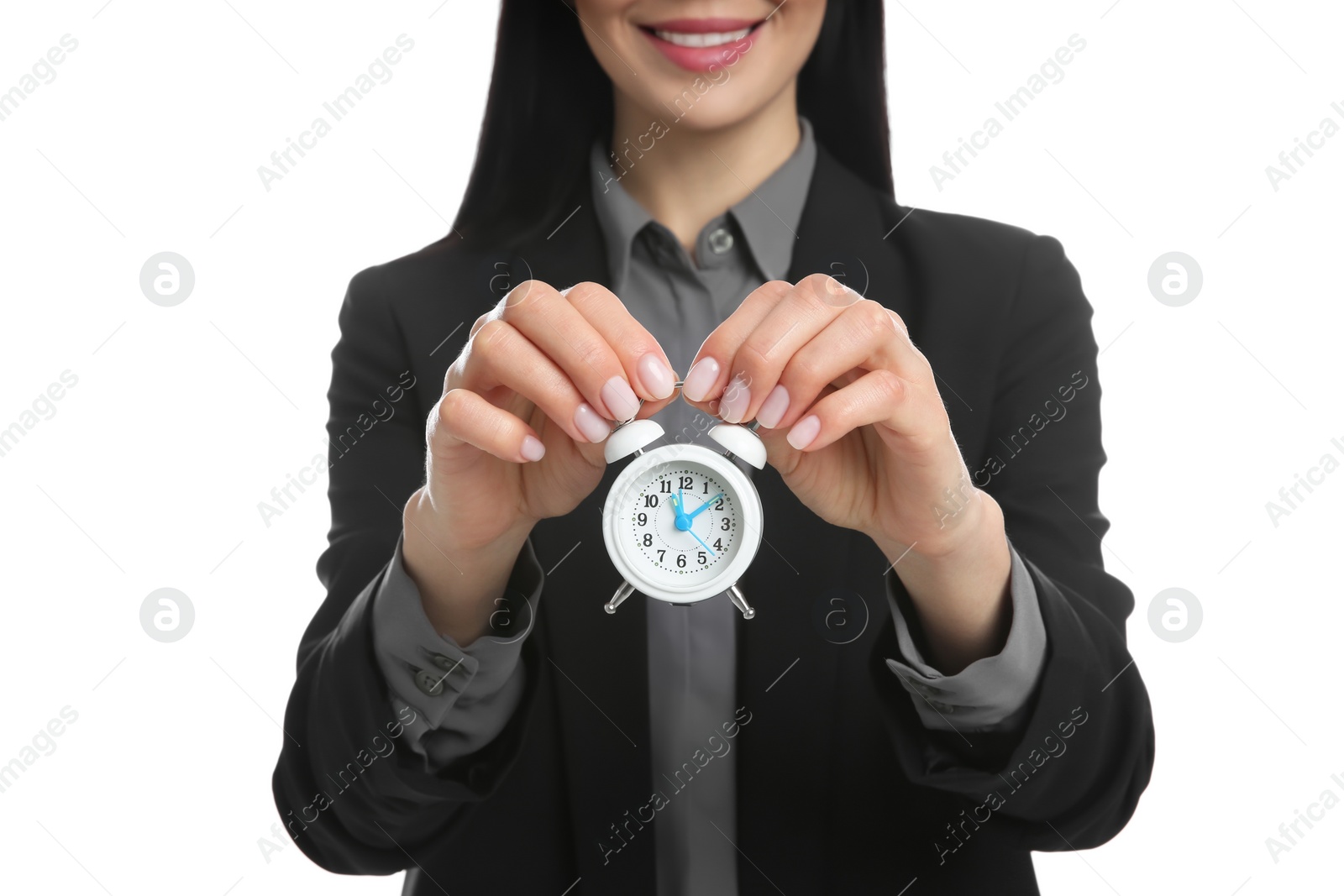 Photo of Businesswoman holding alarm clock on white background, closeup. Time management