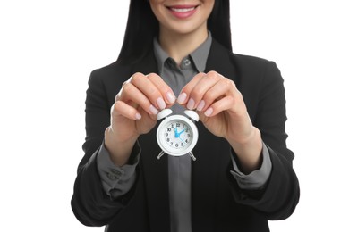 Businesswoman holding alarm clock on white background, closeup. Time management