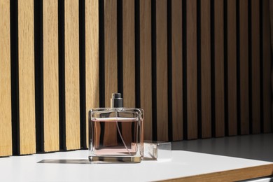 Photo of Bottle of luxury perfume on white table