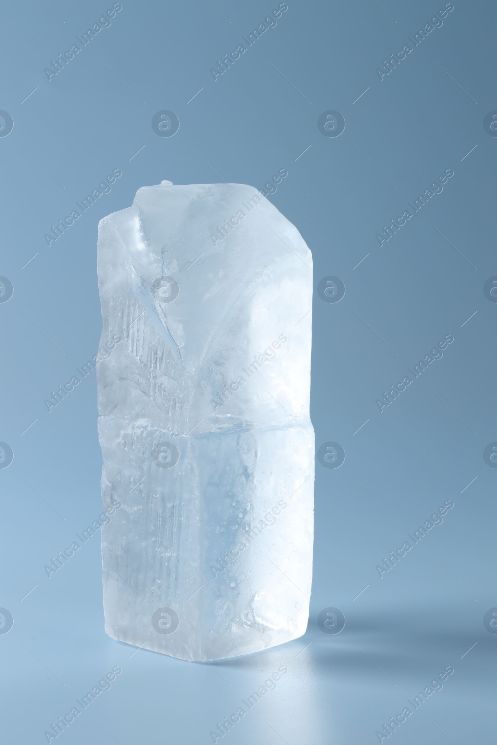 Photo of Blocks of clear ice on light blue background