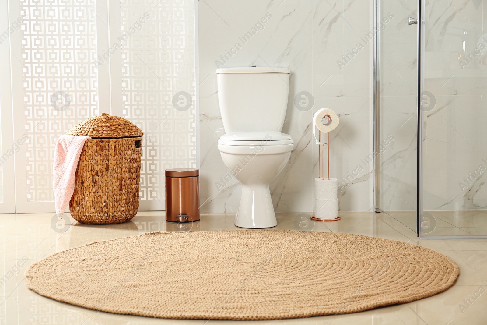 Photo of Toilet bowl near shower stall in modern bathroom interior