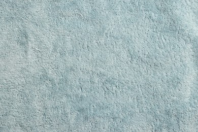 Soft light blue towel as background, top view