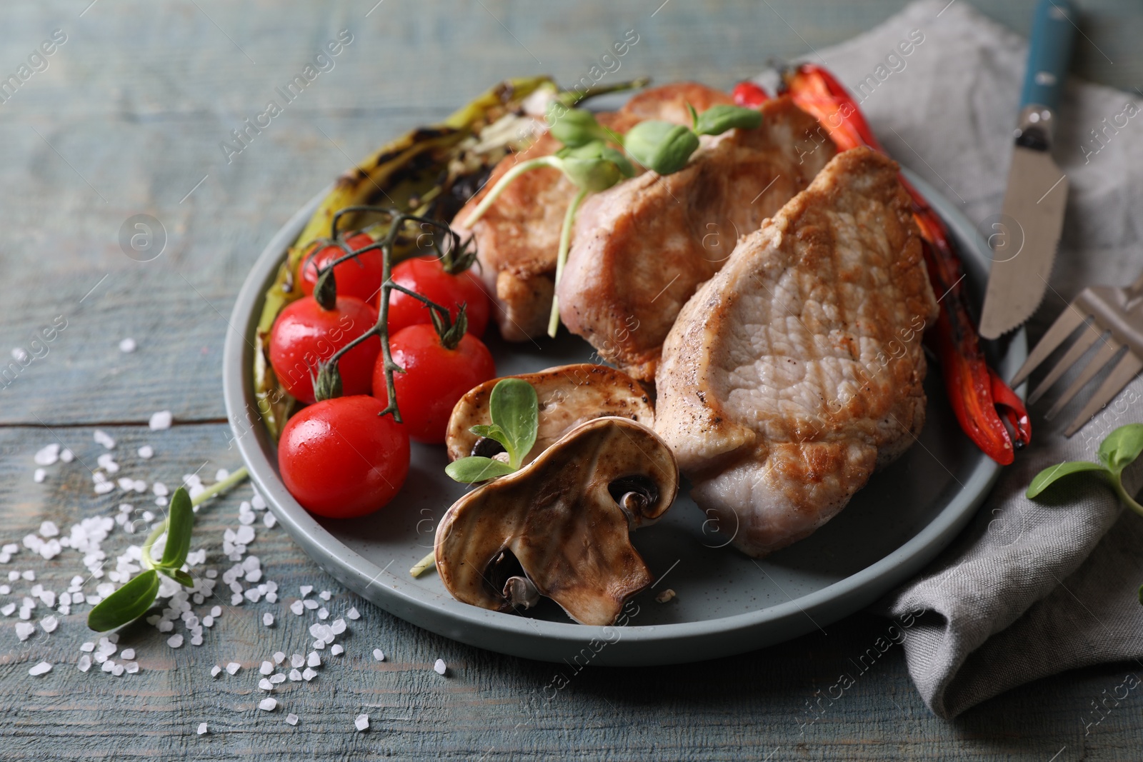 Photo of Delicious grilled meat and vegetables served on wooden table, closeup