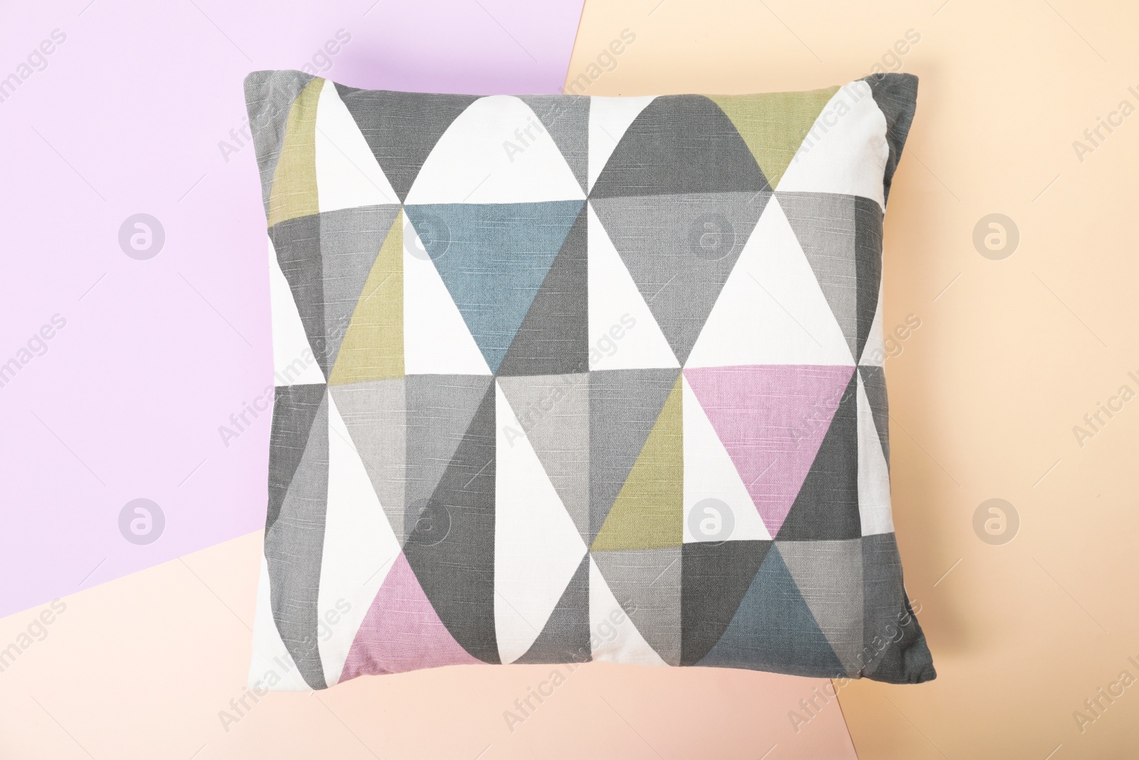 Photo of Soft decorative pillow on color background, top view