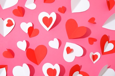 Photo of Small paper hearts on color background, top view