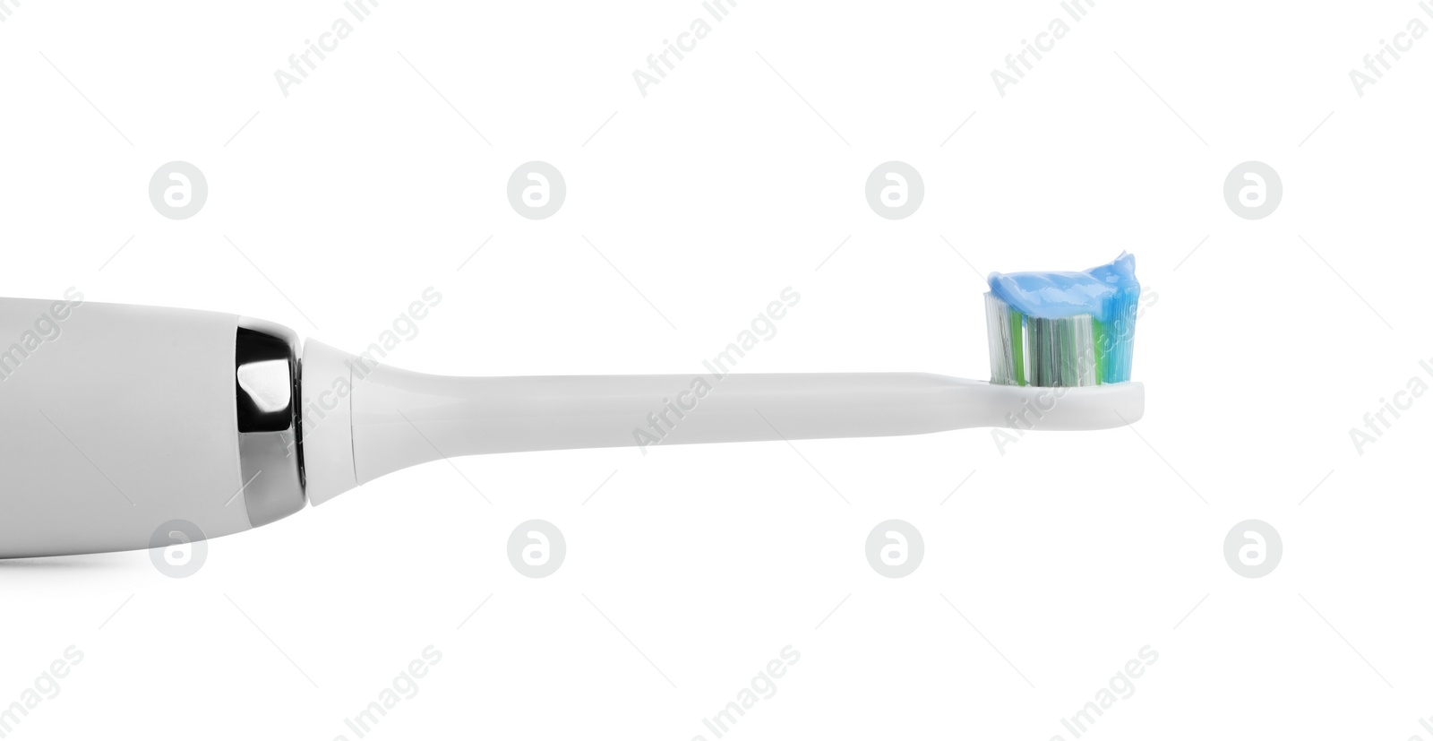 Photo of Electric toothbrush with paste on white background, closeup