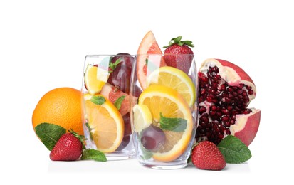 Photo of Glasses and different fruits on white background