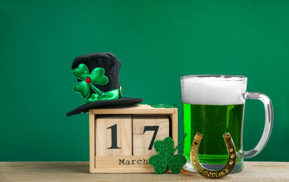 Composition with green beer and clover on wooden table. St. Patrick's Day celebration