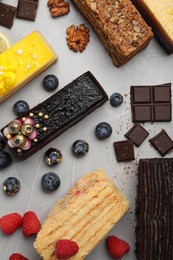 Photo of Flat lay composition with different tasty cakes on light grey table