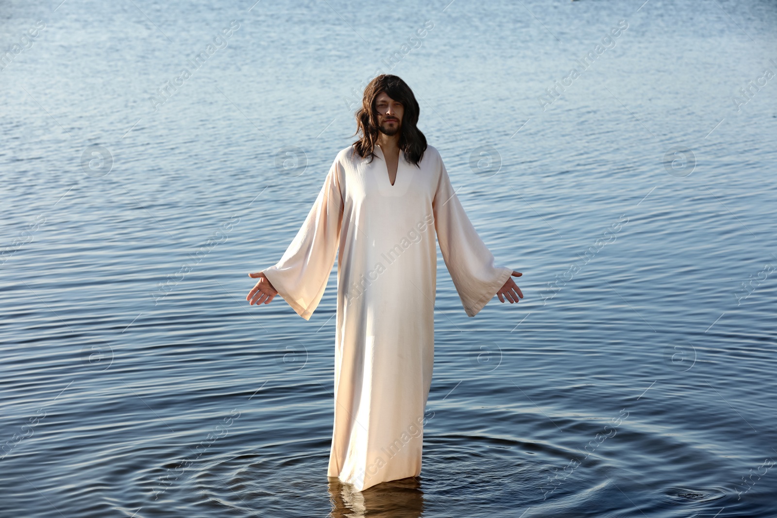 Photo of Jesus Christ in water lit by morning sun