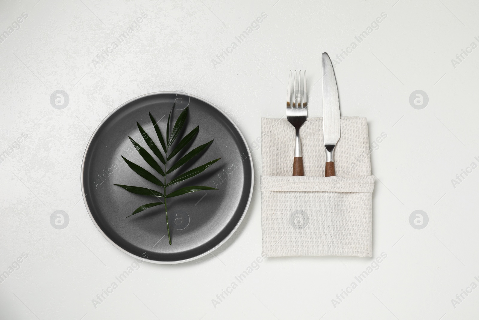 Photo of Stylish setting with elegant cutlery on white table, top view