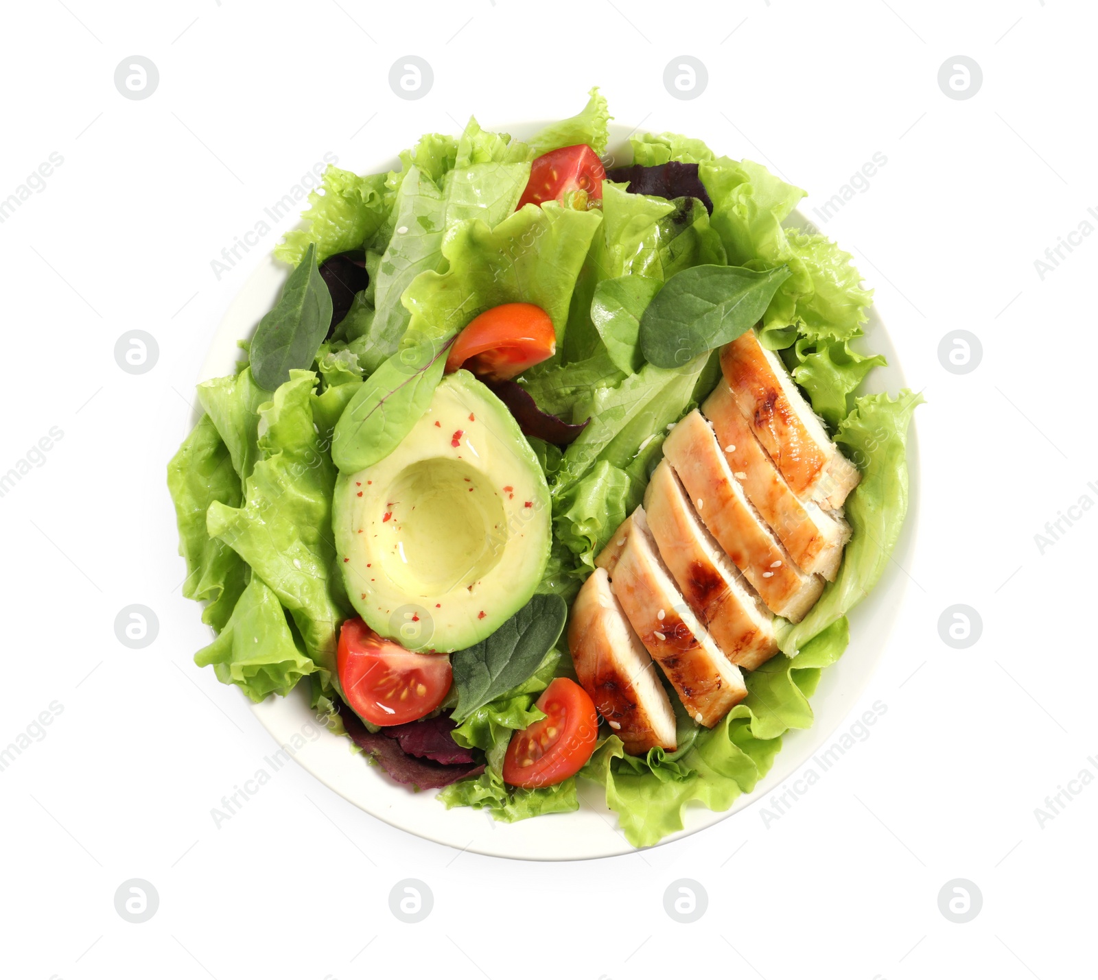 Photo of Delicious salad with chicken, cherry tomato and avocado in bowl isolated on white, top view