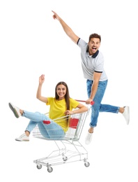 Young couple with shopping cart on white background