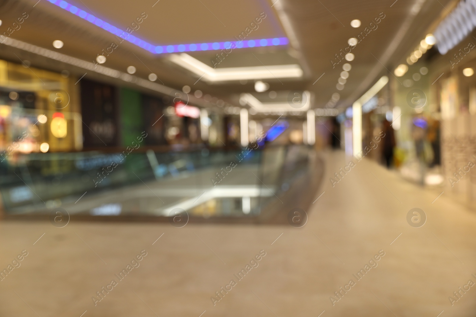 Photo of Blurred view of modern shopping mall interior. Bokeh effect